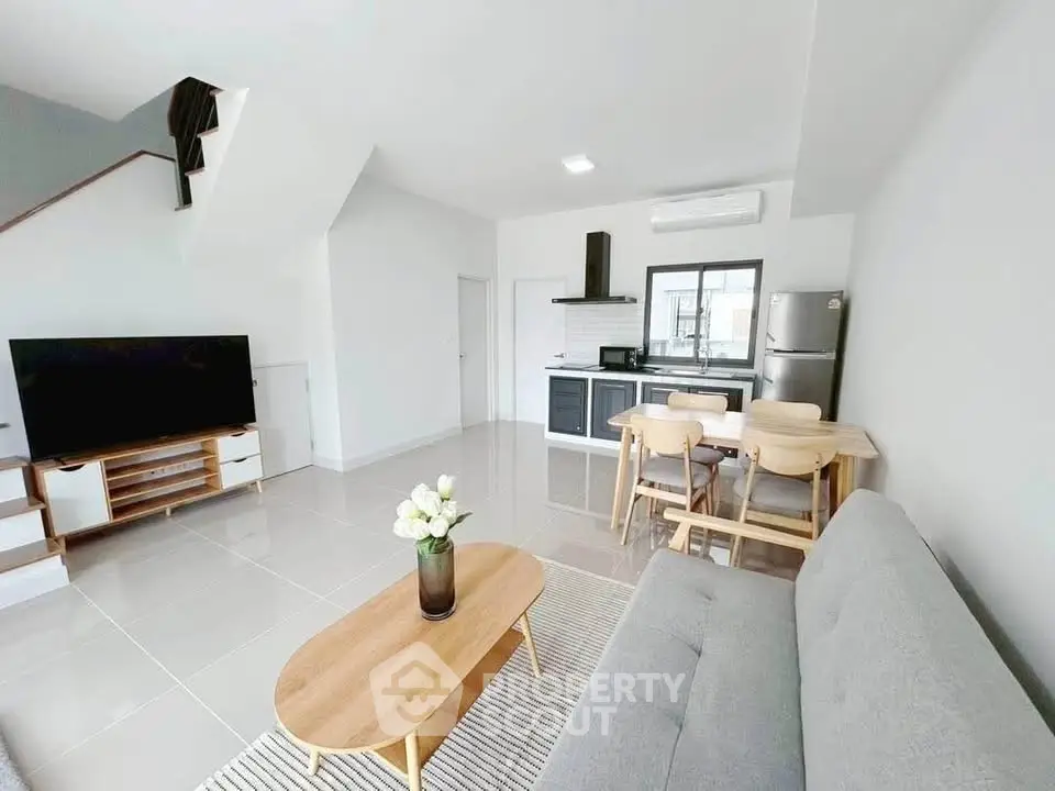 Modern open-plan living room with sleek kitchen and stylish furniture