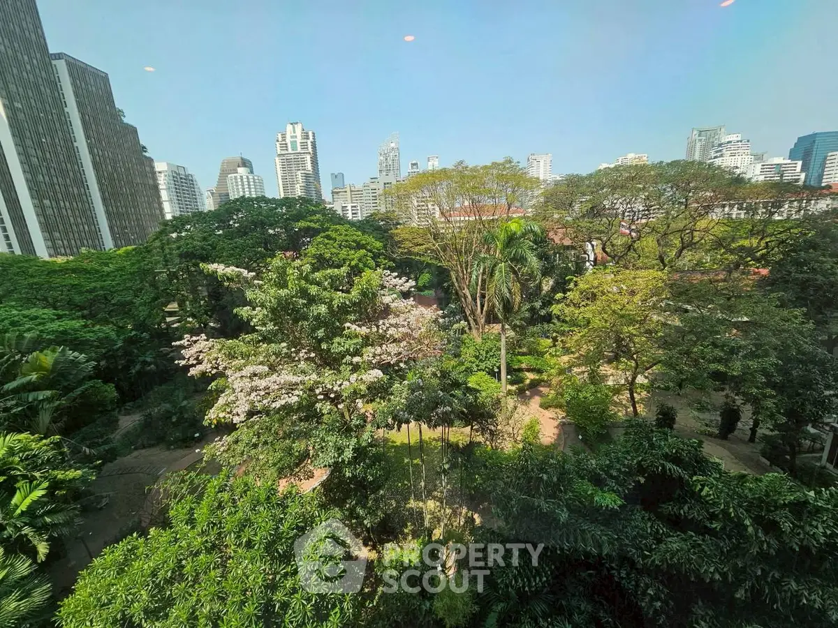 Stunning cityscape view with lush greenery and skyline backdrop, perfect for urban nature lovers.