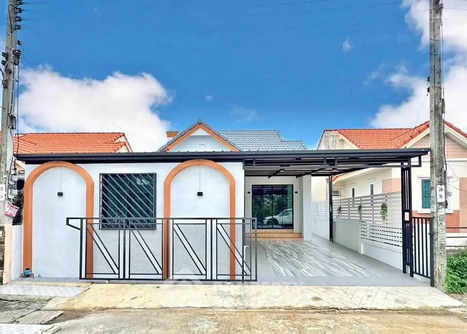 Charming modern single-story house with sleek design and spacious driveway.