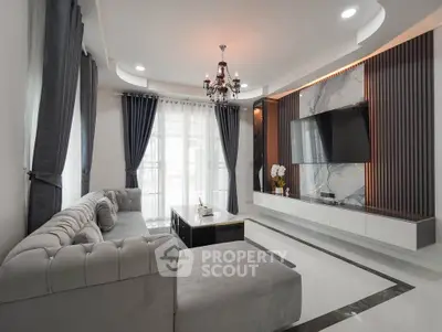 Luxurious modern living room with elegant chandelier and stylish decor
