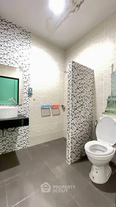 Modern bathroom with mosaic tiles and stylish fixtures in a contemporary apartment.