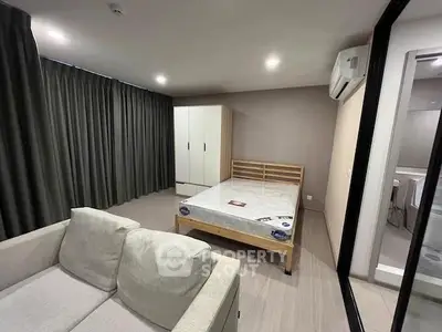 Modern bedroom with cozy sofa and large wardrobe in stylish apartment
