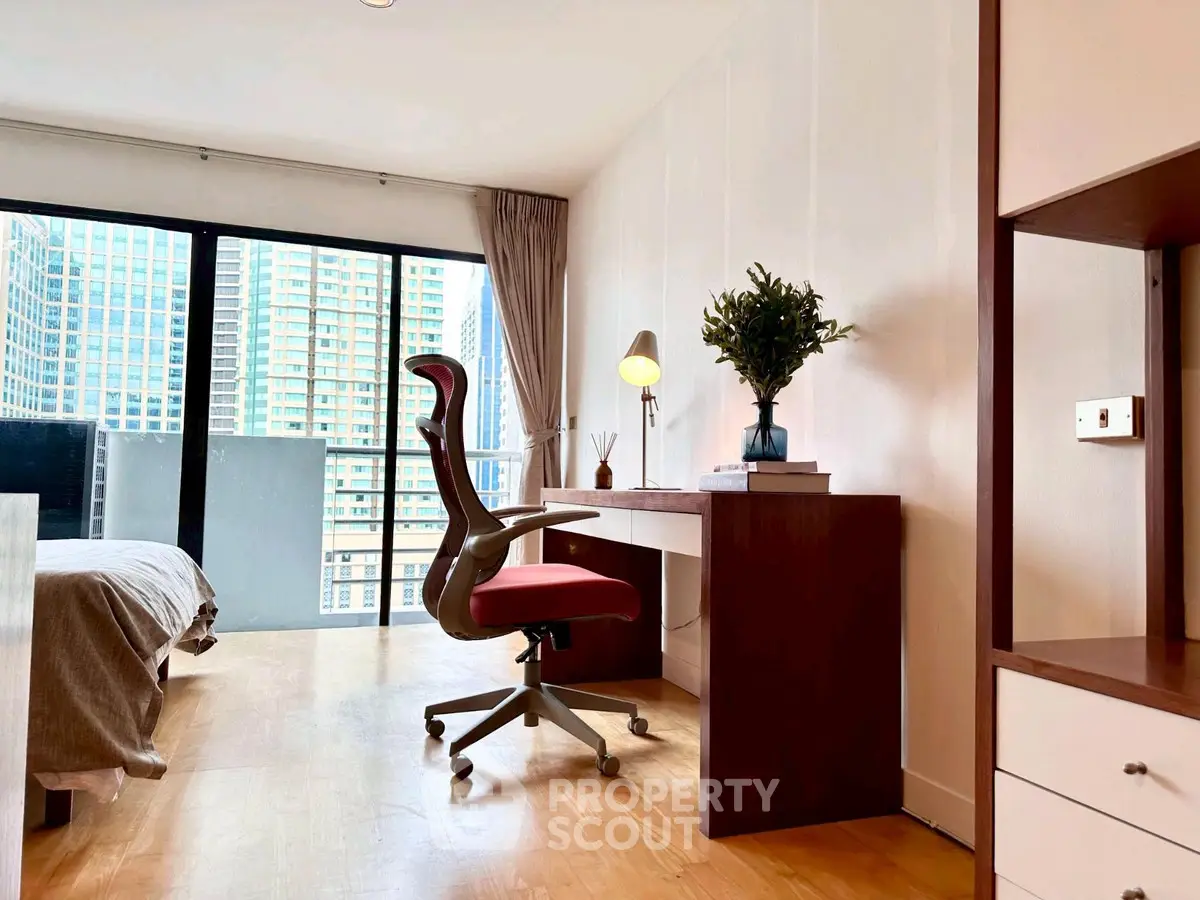 Modern bedroom with study area and city view balcony in luxury apartment