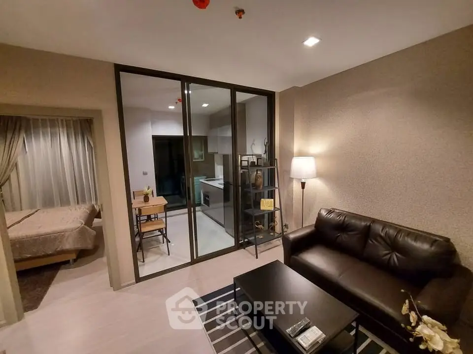 Modern living room with glass partition, cozy sofa, and stylish decor