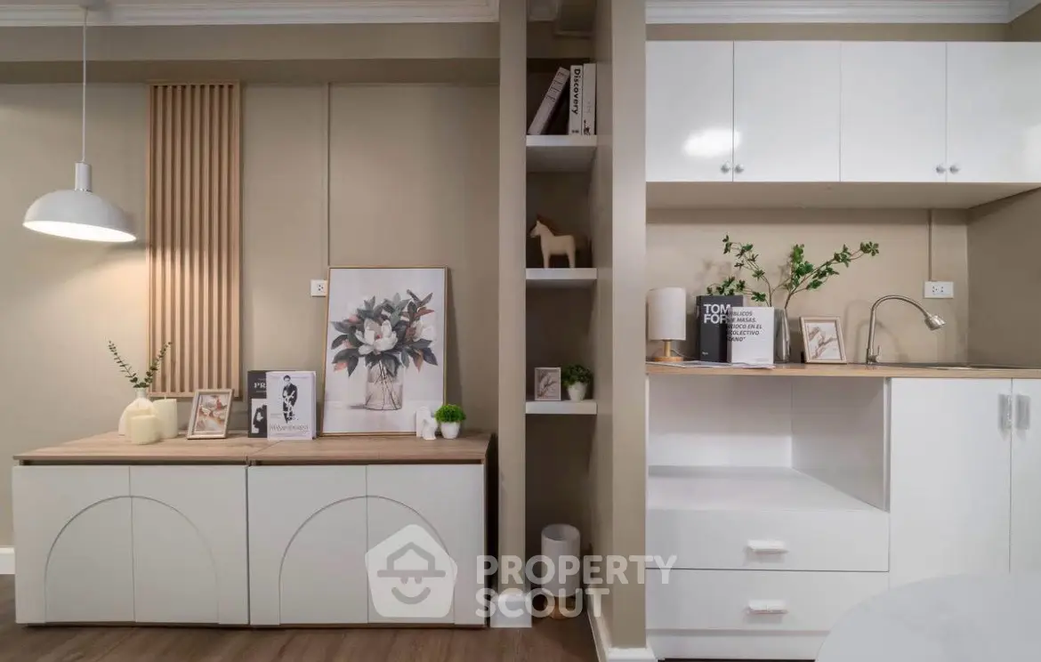 Modern kitchen with sleek cabinetry and stylish decor in a contemporary apartment.