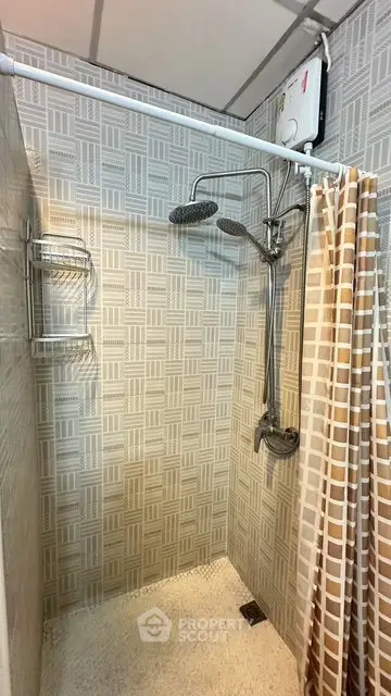 Modern bathroom with shower and stylish tile design, featuring a sleek showerhead and curtain.