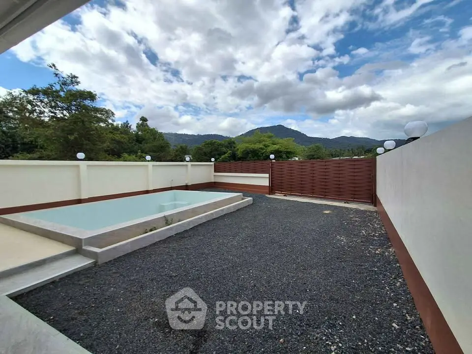 Spacious outdoor area with pool and scenic mountain views, perfect for relaxation and entertainment.