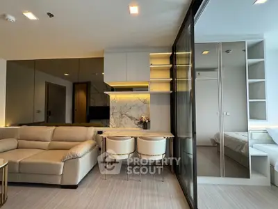 Modern open-plan living room with elegant beige sofa and stylish dining area