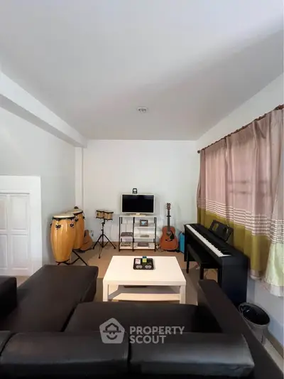 Spacious living room with musical instruments and modern decor