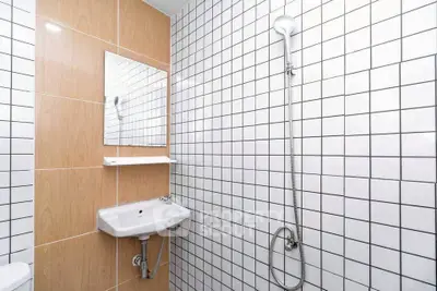 Modern bathroom with white tiled walls and sleek fixtures