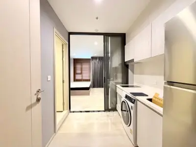 Modern apartment interior with sleek kitchen and laundry area