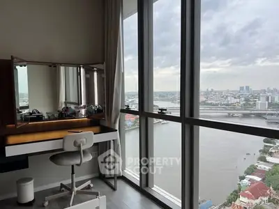 Stunning high-rise apartment with panoramic river view and modern study area.