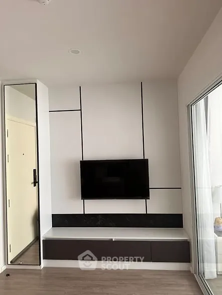 Modern living room with sleek TV setup and stylish wall design
