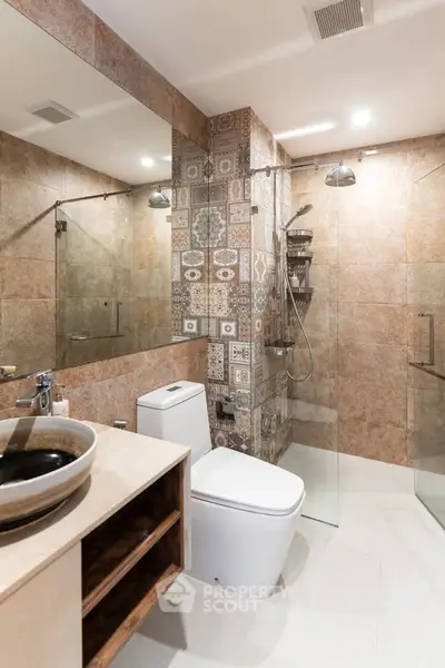 Modern bathroom with stylish tiles and glass shower enclosure
