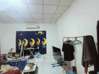 Cozy bedroom with unique decor and practical storage solutions, featuring a comfortable bed and air conditioning.