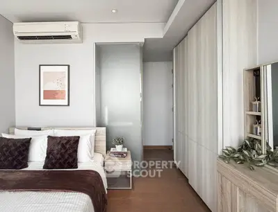 Modern bedroom with sleek design, featuring a cozy bed, stylish decor, and ample storage space.