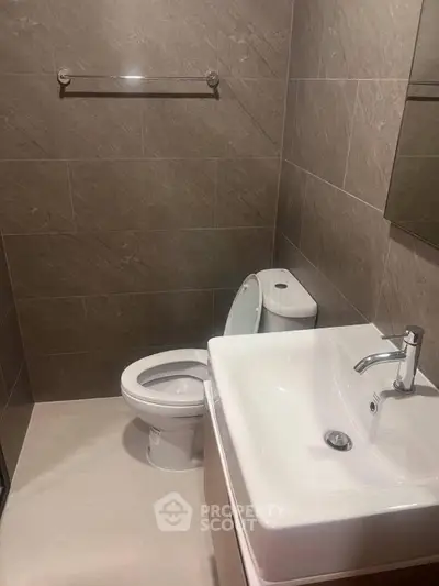 Modern bathroom with sleek fixtures and neutral tile design