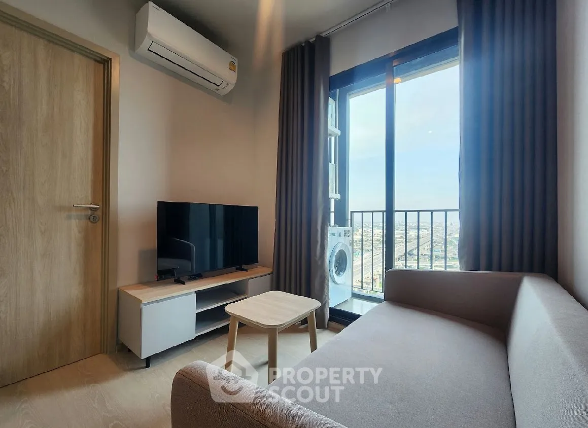 Modern living room with balcony view, featuring sleek furniture and natural light.