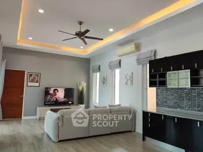 Modern living room with stylish ceiling lights and cozy sofa