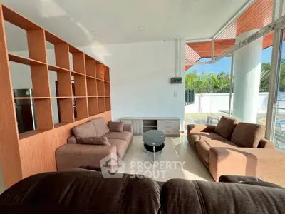Spacious living room with modern furniture and large windows offering natural light.