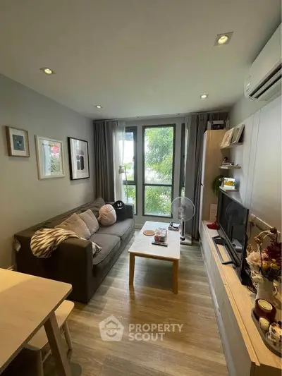 Cozy living room with modern decor and large window view