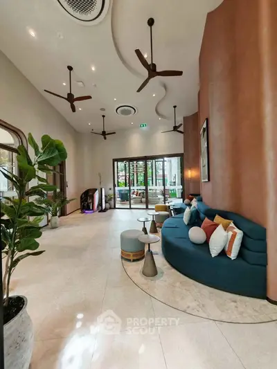 Stylish modern lobby with elegant seating and ceiling fans, perfect for welcoming guests.