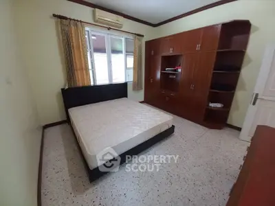 Spacious bedroom with built-in wardrobe and large window