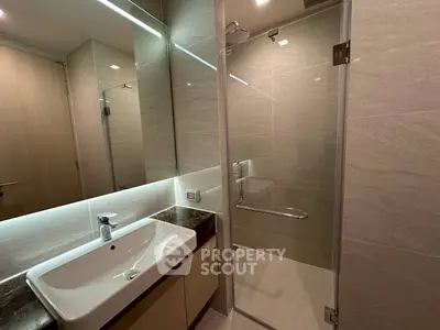 Modern bathroom with sleek glass shower and elegant sink design