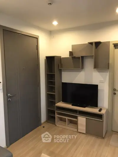 Modern living room with stylish TV unit and wooden flooring