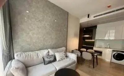 Modern living room with stylish kitchen and cozy seating area in open layout apartment.