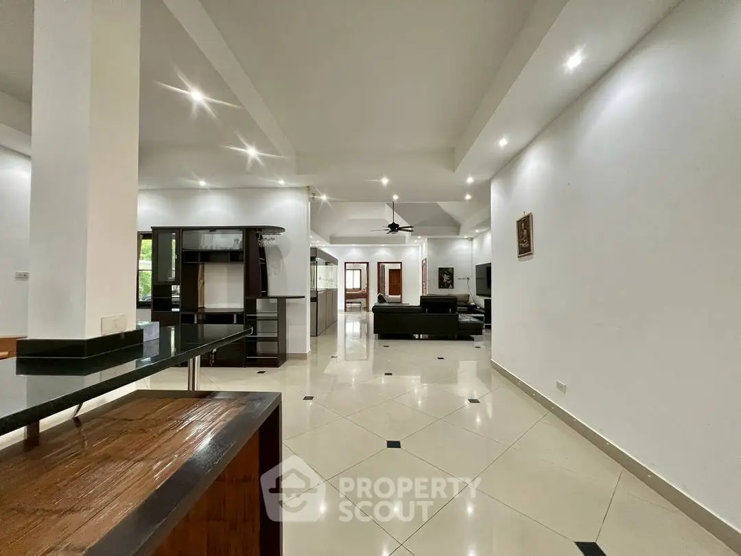 Spacious open-plan living room with modern design and elegant lighting