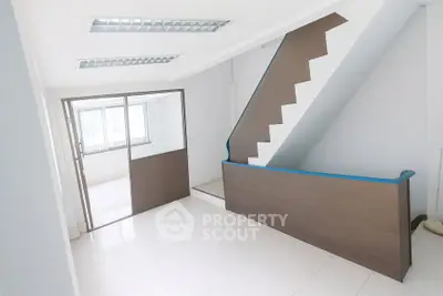 Bright interior space with modern staircase and glass partition