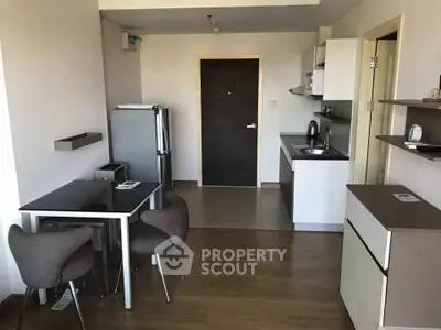 Modern apartment kitchen with dining area and sleek appliances