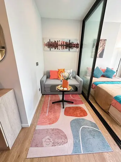 Stylish small living area with modern decor and cozy seating in a compact apartment.