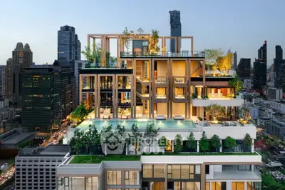 Luxurious rooftop pool with stunning city skyline view in modern high-rise building.