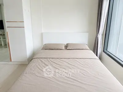 Modern bedroom with minimalist design and large window for natural light