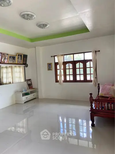 Spacious living room with large windows and elegant decor