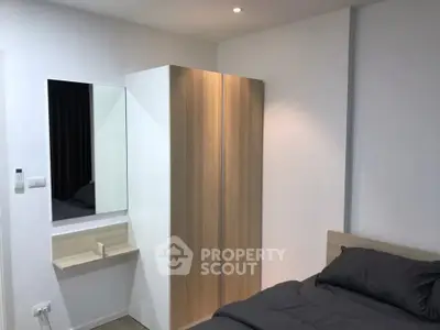Modern bedroom with sleek wardrobe and cozy bed in minimalist design.