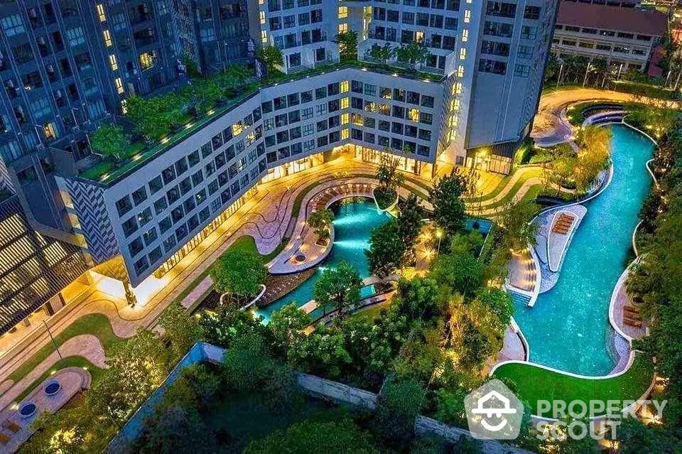 Luxurious condominium with stunning pool and lush garden view at night