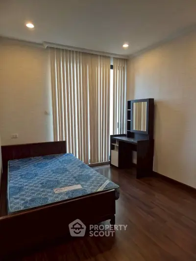 Cozy bedroom with wooden flooring and modern furniture