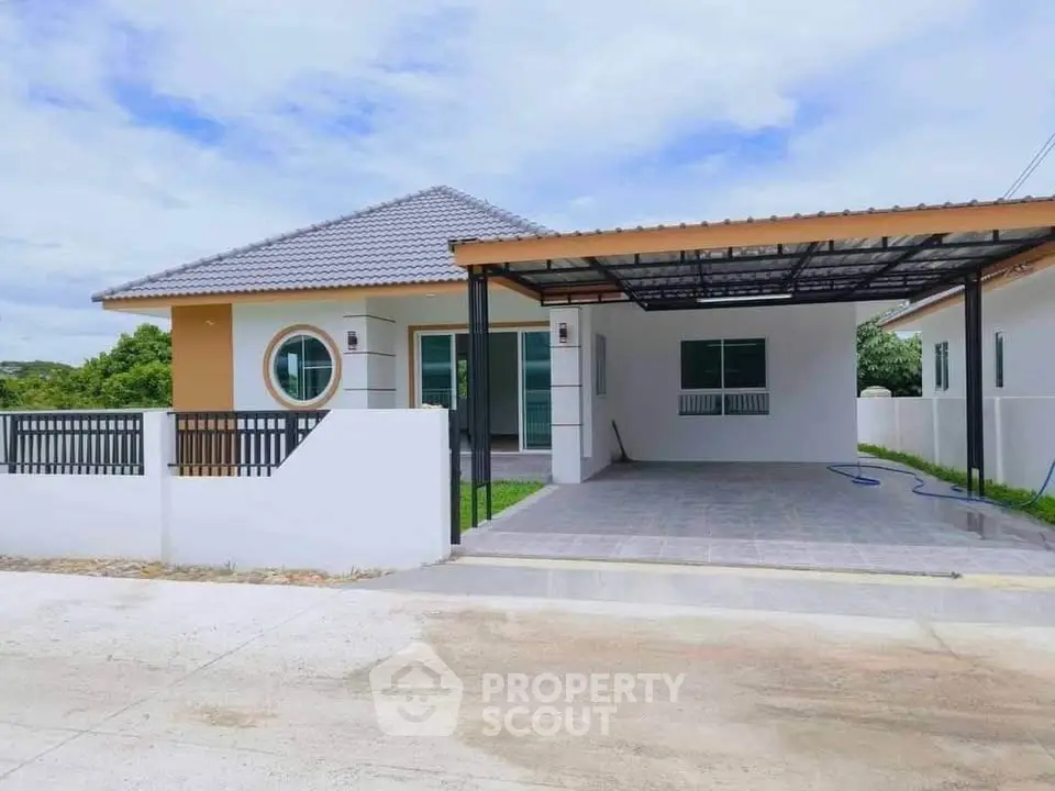 Charming single-story house with modern design and spacious carport in a serene neighborhood.