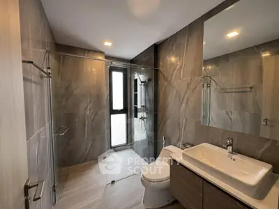 Modern bathroom with sleek design and large mirror in luxury apartment