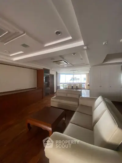 Spacious living room with elegant ceiling design and cozy seating area.