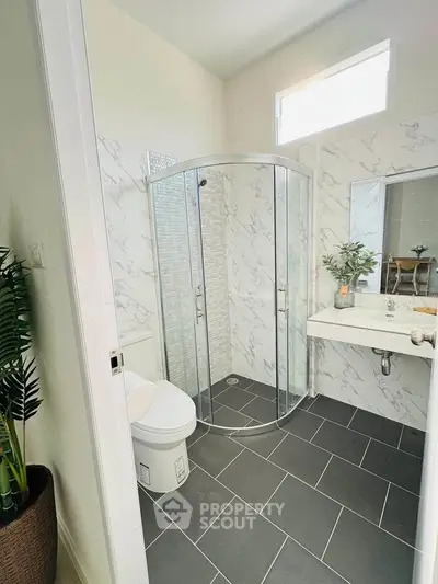 Modern bathroom with sleek shower and elegant marble walls