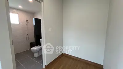 Modern minimalistic bathroom with wooden flooring and white tiles