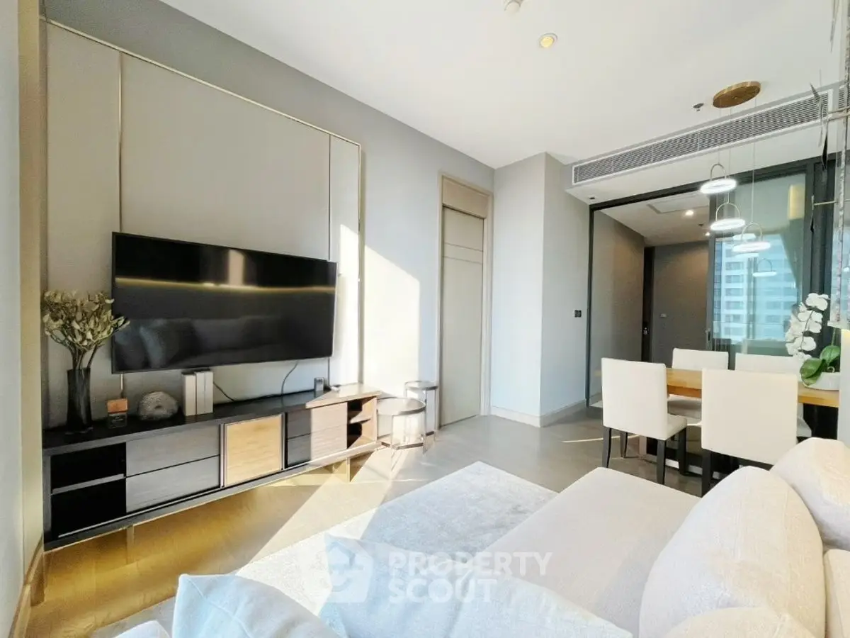 Modern living room with sleek TV setup and elegant dining area