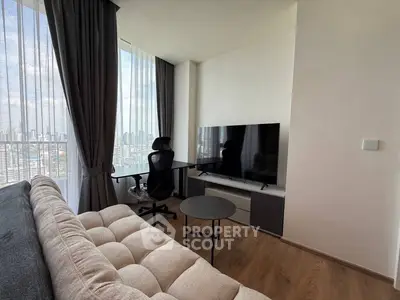 Modern living room with city view, featuring sleek furniture and large TV.