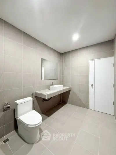 Spacious modern bathroom with sleek fixtures and neutral tile design
