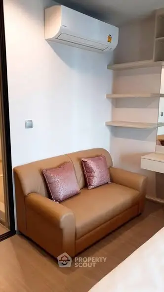 Cozy living room with modern sofa and air conditioning unit