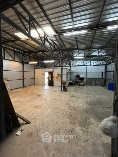 Spacious industrial warehouse with high ceilings and ample storage space.